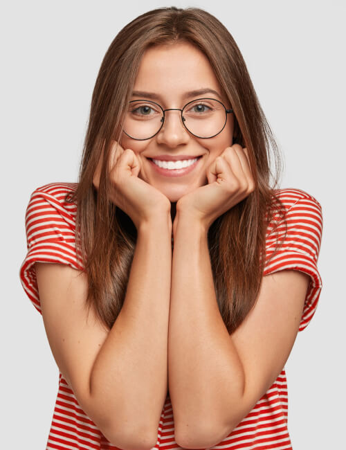 Brunette teenager with glasses on a blank background