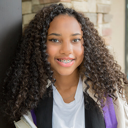 School girl with curly hair smiling